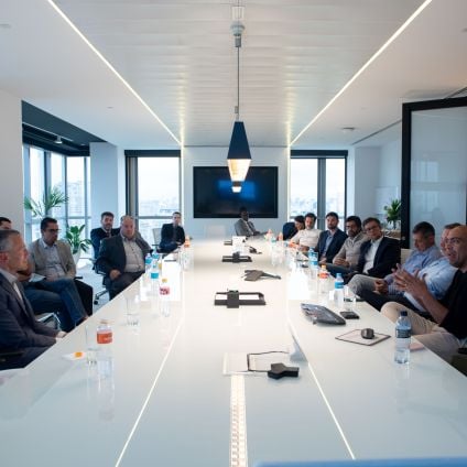 A group of people sit around a table for a discussion