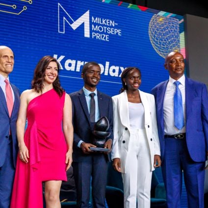 A group of people stand on stage at an event