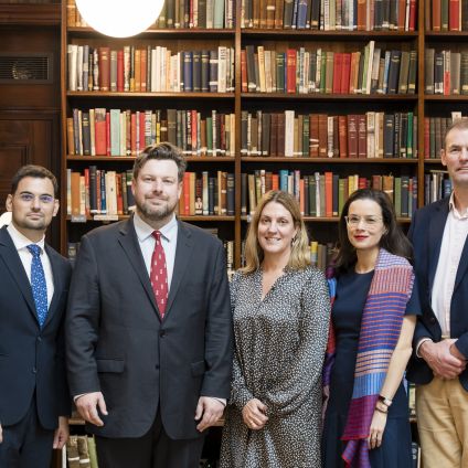 Photo of speakers from the Milken Institute