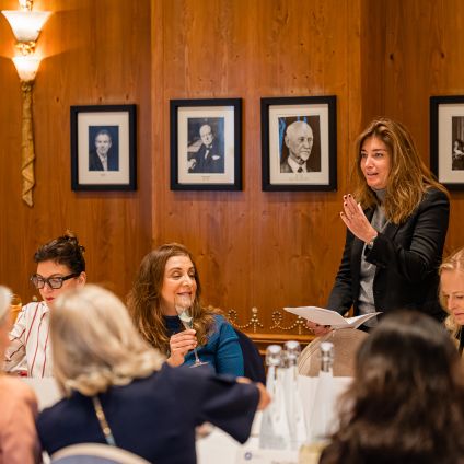 Photo of speakers from the Milken Institute
