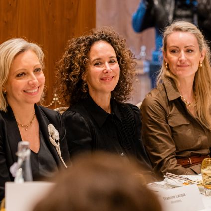 Photo of speakers from the Milken Institute