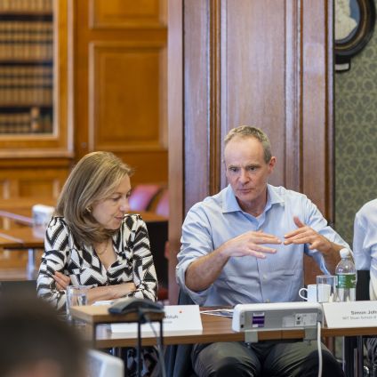 Photo of speakers from the Milken Institute
