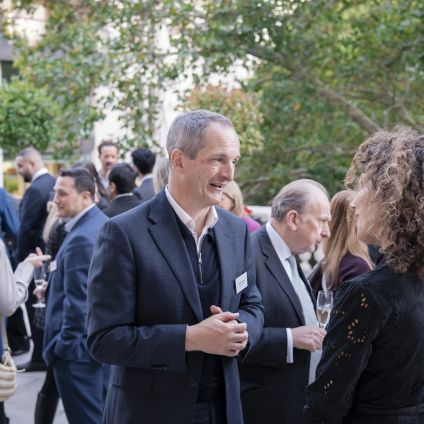 Photo of speakers from the Milken Institute