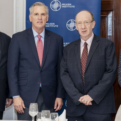 Photo of speakers from the Milken Institute