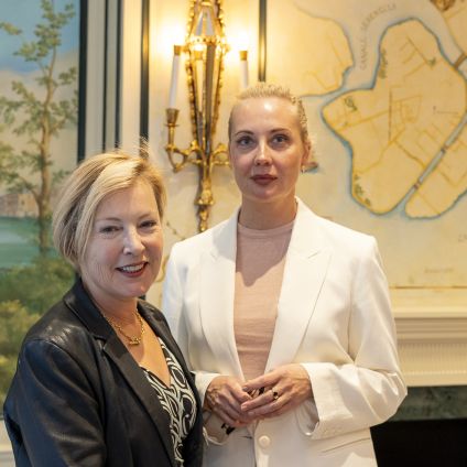 Photo of speakers from the Milken Institute