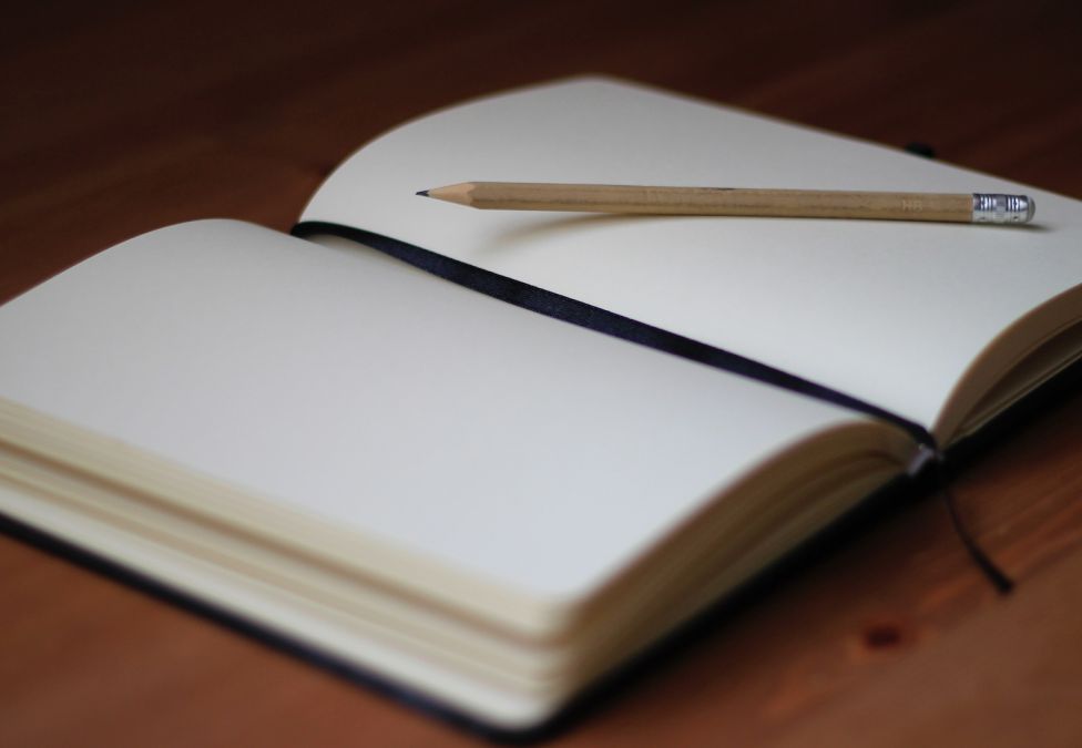 open notebook with a pencil