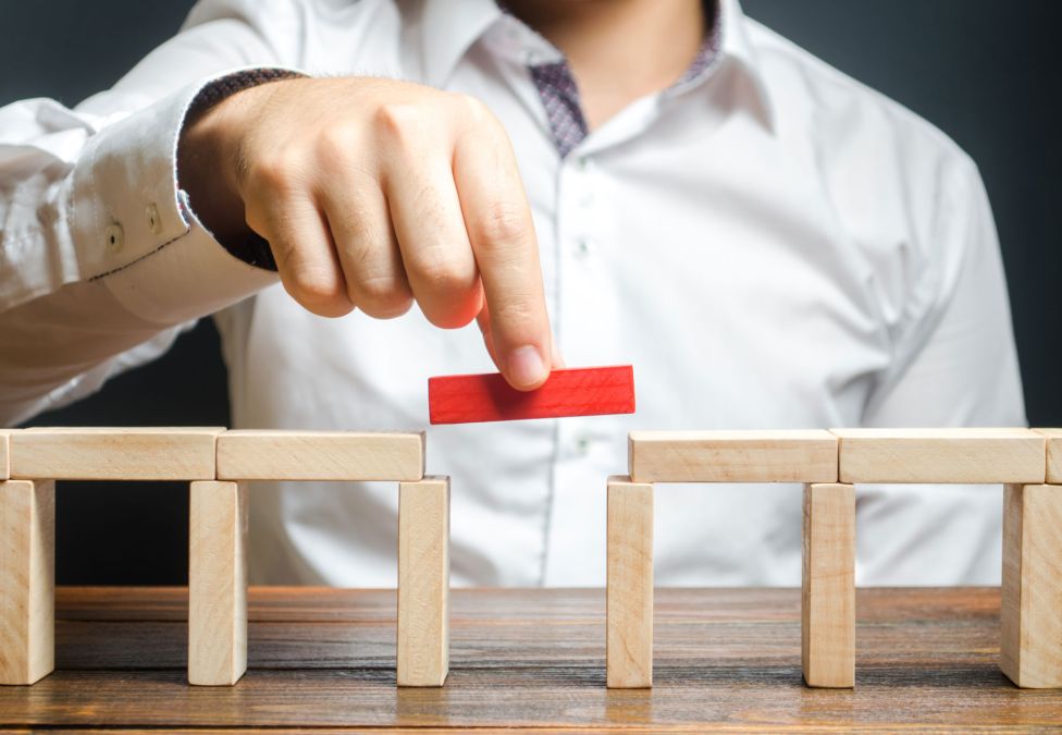 Man assembling wooden blocks.