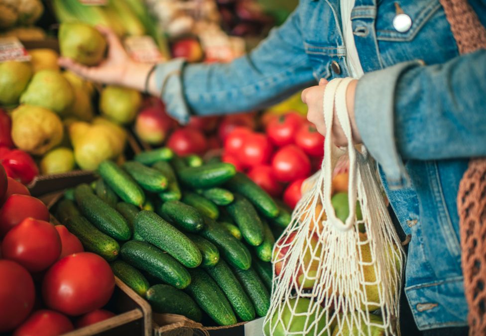 A person selecting fruits and vegetables.