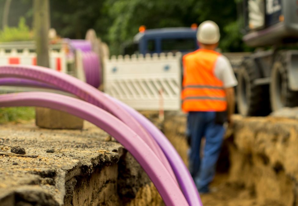 A worker installing broadband cable.