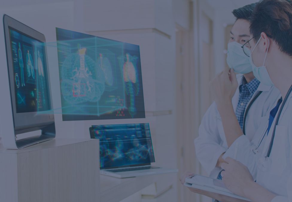 two doctors look at scans on computers