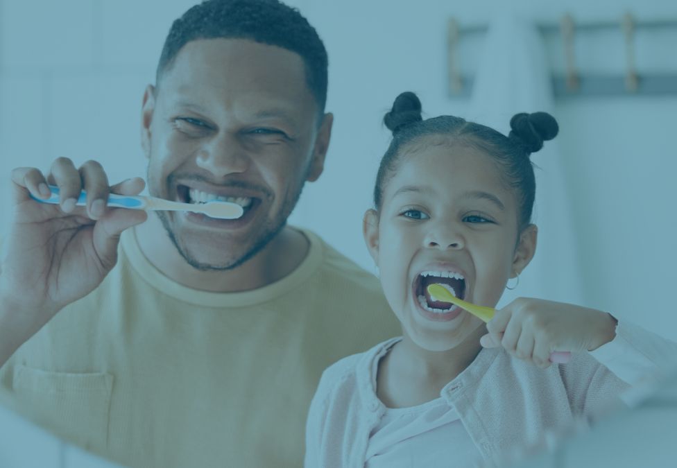 Father and daughter brushing teeth