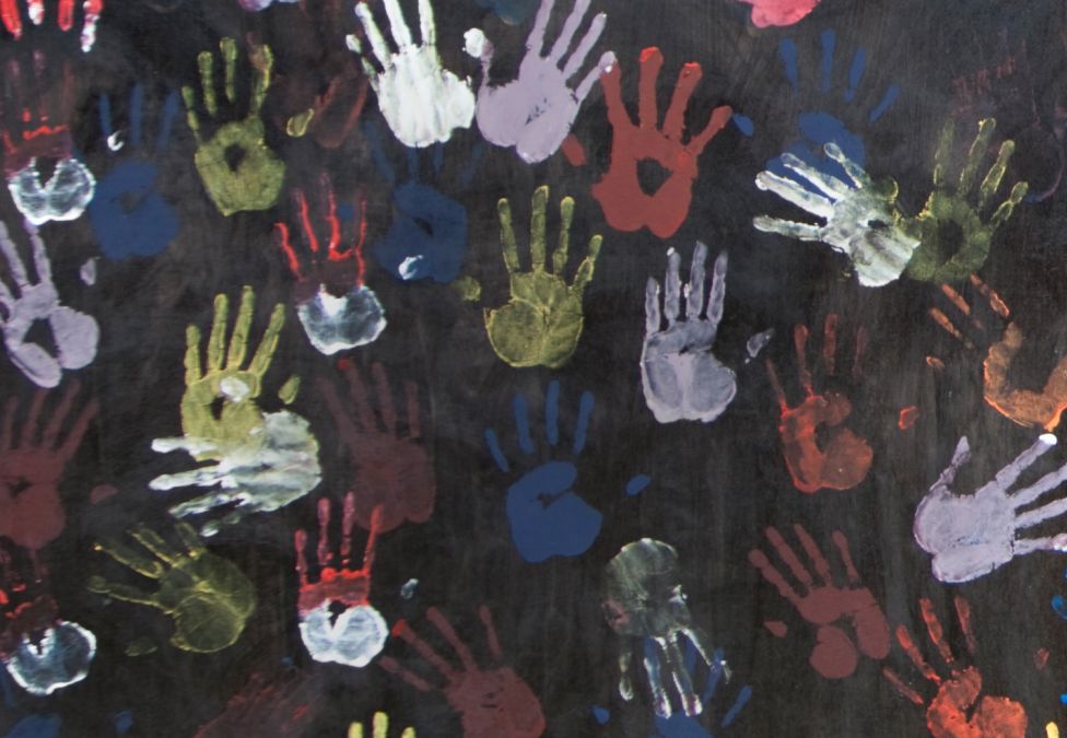 Painted handprints on a black background