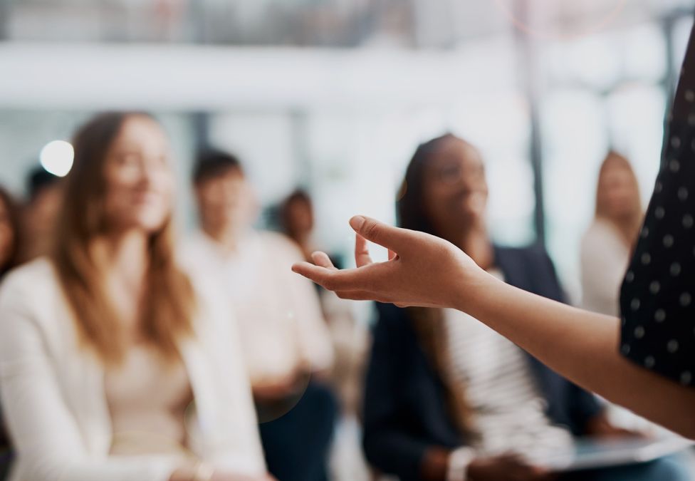A speaker talking to a room of people