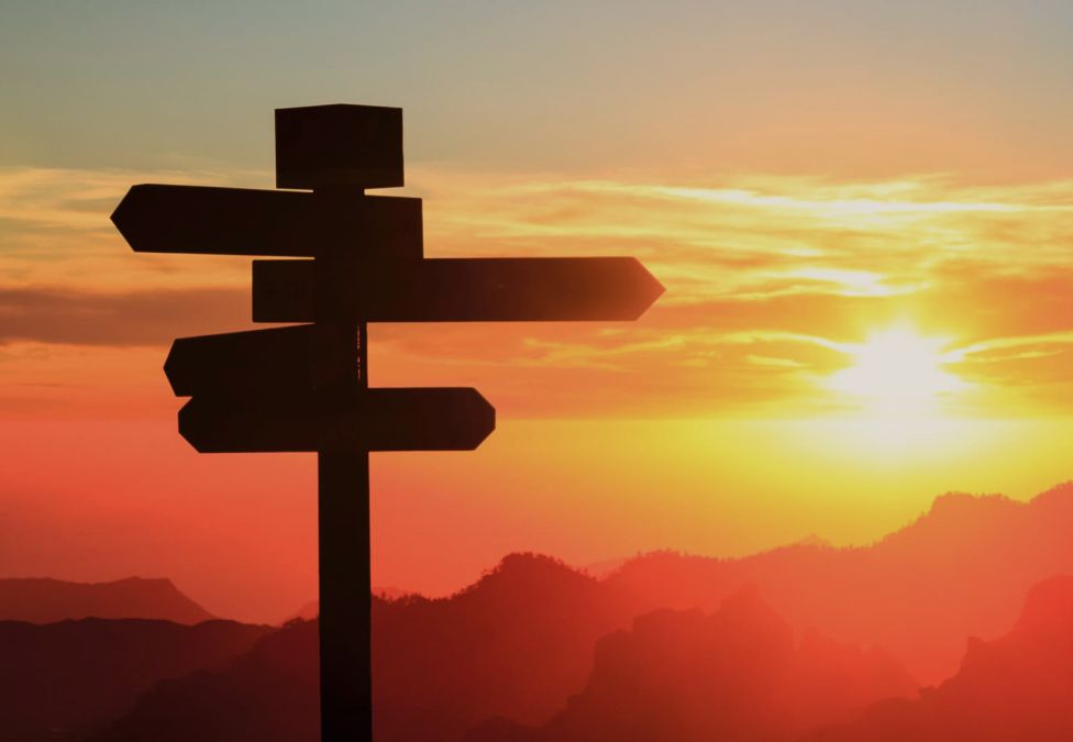 A roadsign against a sunset backdrop