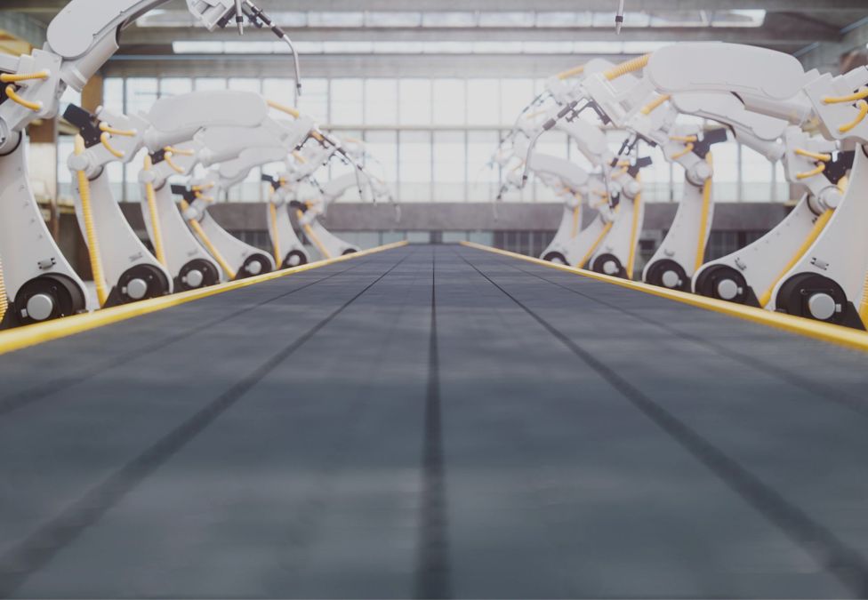 Robotic arms on a conveyor belt