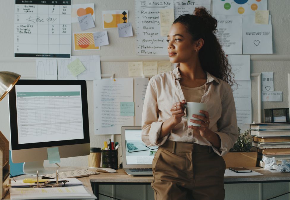woman in an office with computer and books