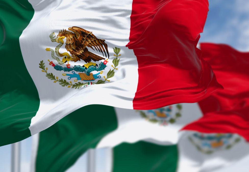 Three Mexican flags blowing in the wind