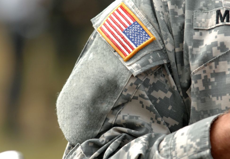 Close up of the American flag on the arm of a US military member.