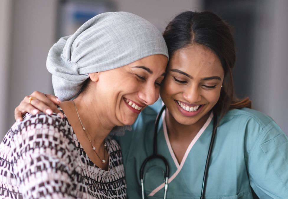 A patient and a doctor laughing together.