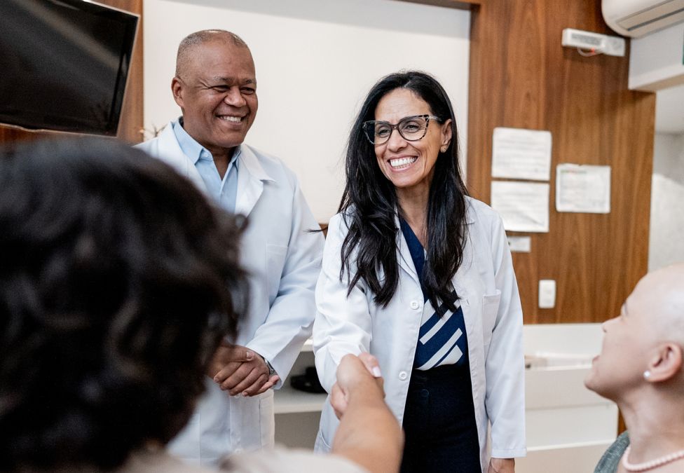 A doctor shakes the hand of a patient.
