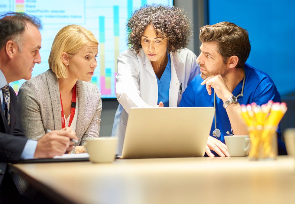 A group of people around a laptop