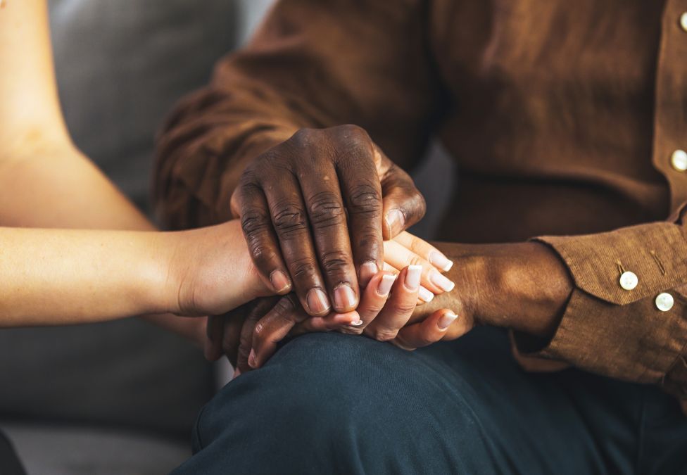 Two people holding hands