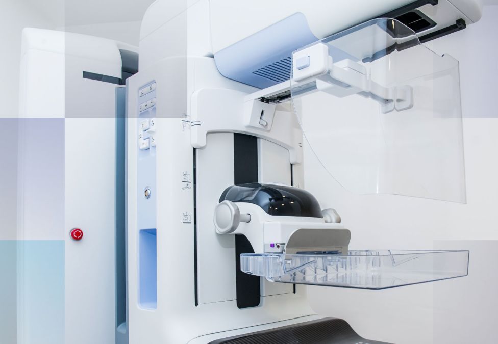 Picture of a large mammography machine with rounded parts