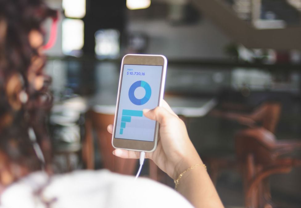 Abstract 3D render of glossy translucent panels arranged in a wave, transitioning from purple to orange.