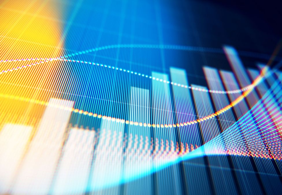 Financial data visualization with colorful bar charts and curved lines on digital display