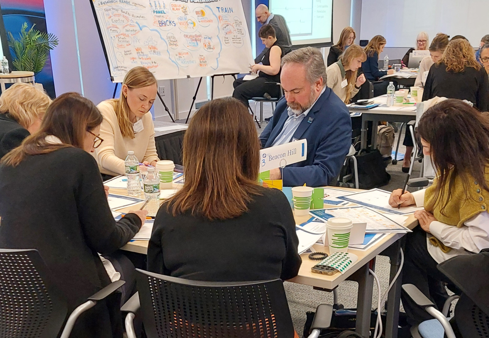 Business professionals attending a meeting or workshop in a bright conference room
