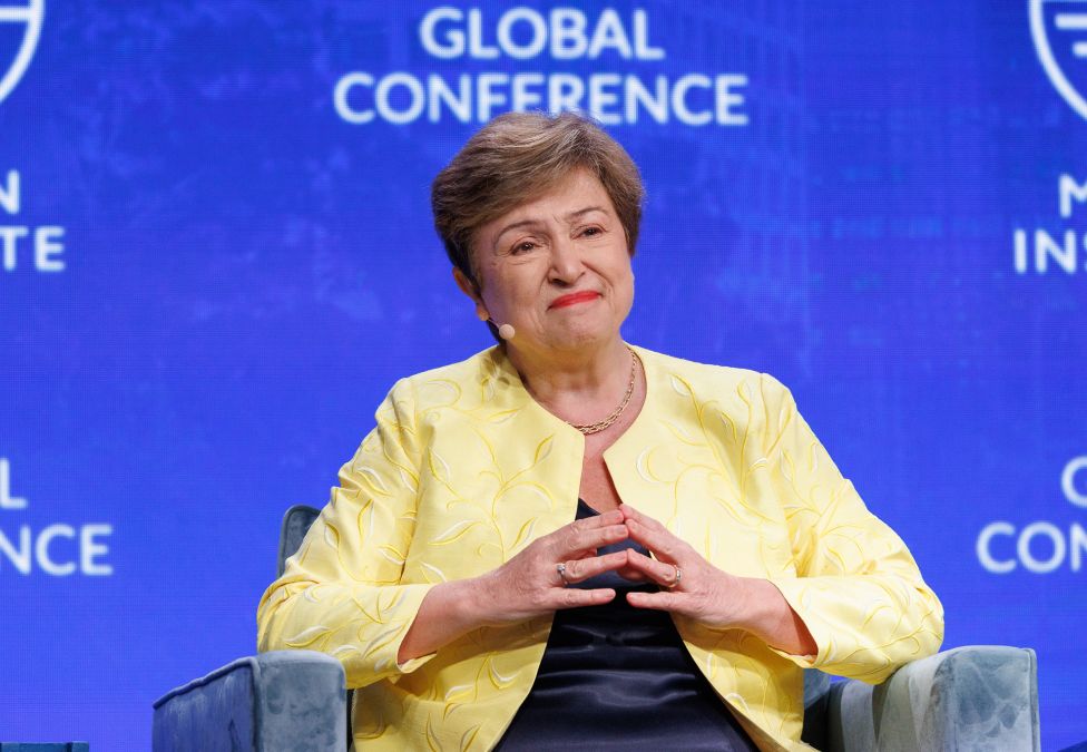 Woman in yellow blazer speaking at Global Conference podium
