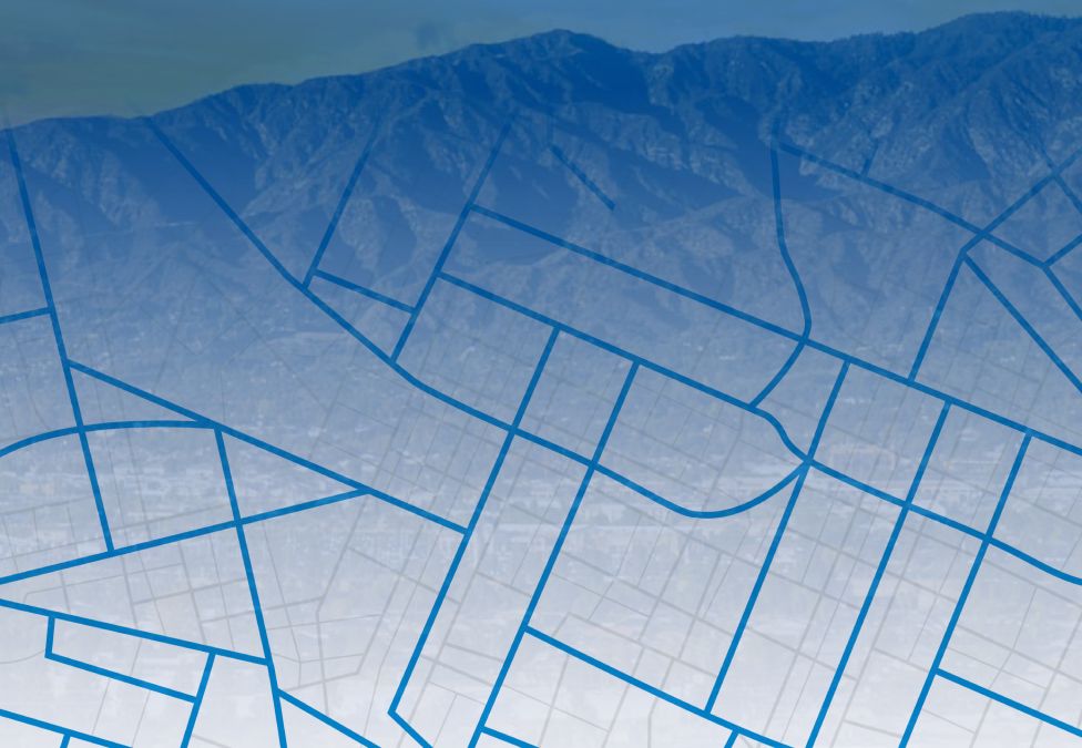 Architectural blueprint with building floor plans against mountain backdrop